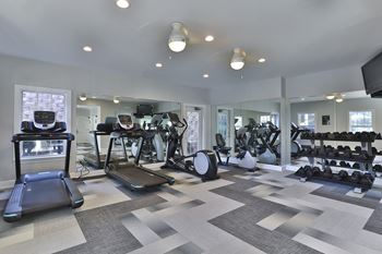 A gym with treadmills and other exercise equipment